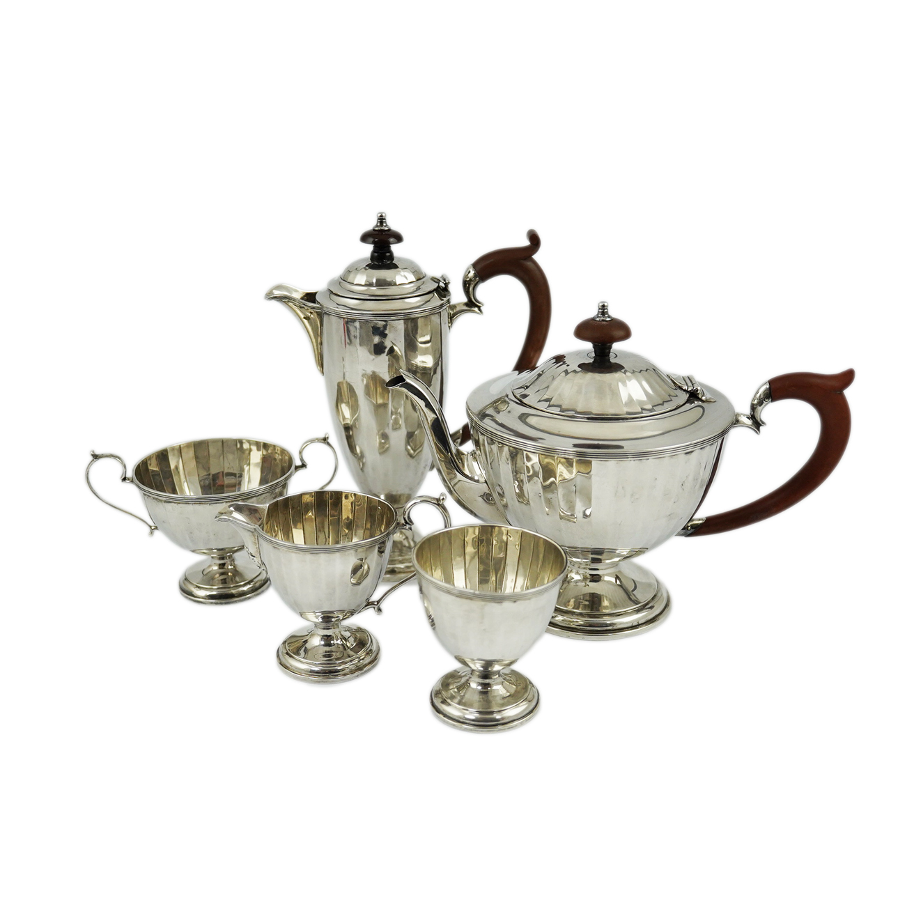 A George V panelled silver five piece tea set by Adie Brothers